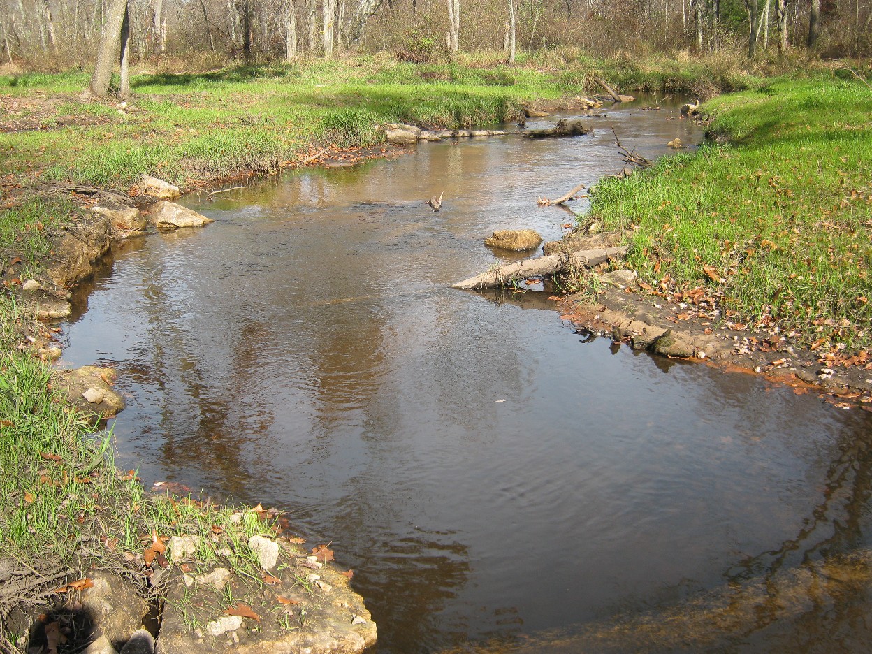 Logs shaping boulders looking upstream