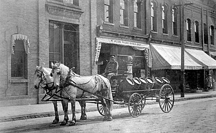 Baraboo: North side of 3rd Street. Effinger Brewery beer wagon in front of Jacob's Palace Barber Shop.