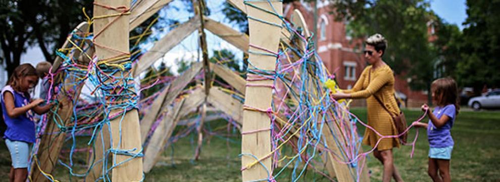 Participants create the scales for the Polychrome Walleye, a project funded by Sauk County Arts & Culture grant program.