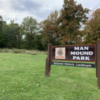 Sign at Man Mound with effigy mound in background