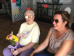 Two women welcome people into one of the Exhibit Building at the Sauk County Fair.