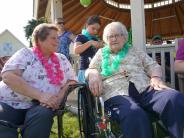 Staff enjoying Luau with resident.