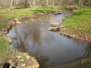 Logs shaping boulders looking upstream