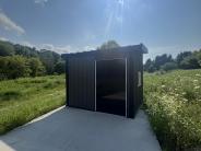 Accessible hunting blind with green grass, woods and sky 