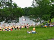 Park visitors enjoy the beach on a summer day