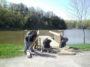 Six individuals work together to build the pier at the North End boat landing on Lake Redstone