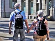two older adults with backpacks