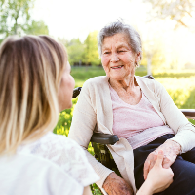 Older person smiling with younger person