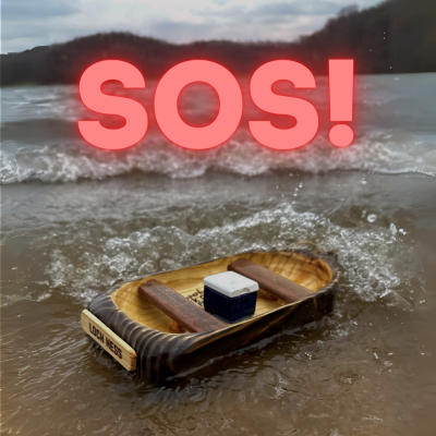 The words SOS! displayed in bright red over a picture of a small wooden boat floating on White Mound Lake
