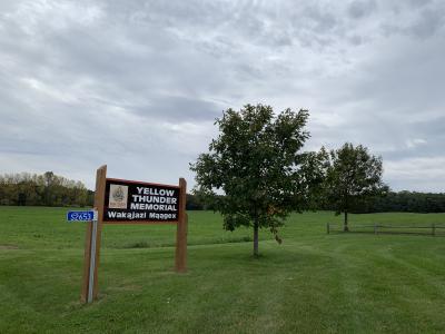 Yellow Thunder sign with trees