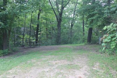 Campsite at White Mound County Park Campground surrounded by trees