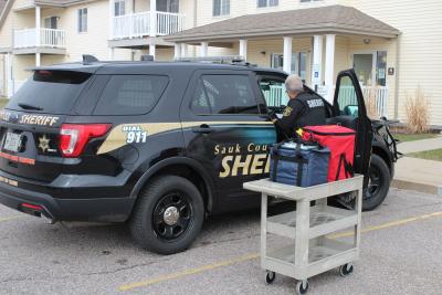 Deputy Wasilewski loading meals into her squad