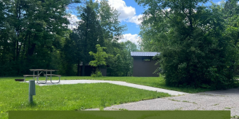 White Mound County Park Campground now open! Image of campsite with picnic table and fire ring, with trees in back