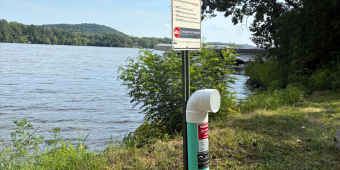 Monofilament Fishing Line Receptacle A monofilament fishing line receptacle is placed near the water at Summer Oaks boat landing, under invasive species sign