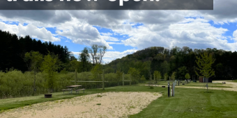 Horse campground and trails now open! Large, open gravel sites with expansive sky and trees in the background.