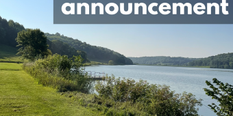 Lost and Found Announcement Lost and found announcement in front of a photo of White Mound Lake, with a grassy picnic area to the side and bluffs behind